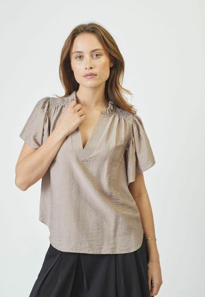 Short-sleeve blouse in light taupe fabric, featuring a V-neck, ruched collar, and a relaxed fit. Textured surface with subtle sheen.