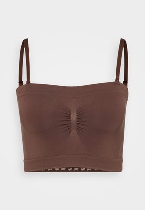 Ruskea saumaton bralette, jossa on säädettävät hihnat, kerätty keskikohta ja alaosassa toistuva logokuvio.