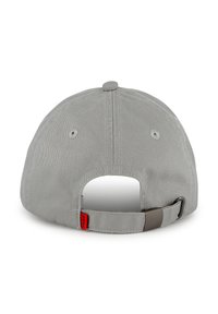 Gray baseball cap with a curved visor, textured fabric, adjustable strap at the back, and a small red brand tag detail.