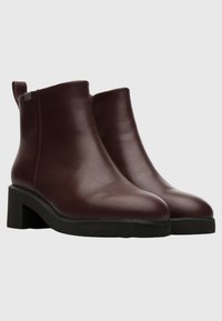 Burgundy leather ankle boots with a rounded toe and a block heel. Features a smooth finish and minimal decorative elements.