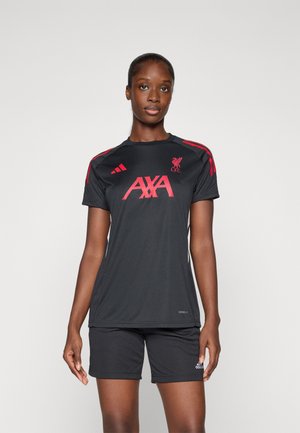 Svart idretts skjorte med røde detaljer, med logoen "AXA" og Liverpool FC-emblemet. Kombinert med matchende svarte shorts laget av lett materiale.
