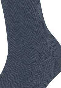 Calze blu scuro realizzate in tessuto testurizzato con motivo herringbone. Il design mette in risalto un aspetto liscio e intrecciato.