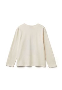 Krémová košile s dlouhým rukávem vyrobená z měkké bavlny. Má zaoblený výstřih, volný střih a boční rozparky na lemu pro pohodlí.