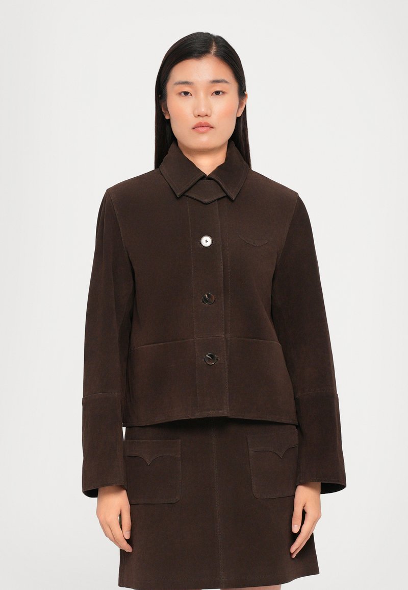 Brown suede jacket with a collared neckline, three buttons, and two front pockets. Features a cropped design and detailed stitching.