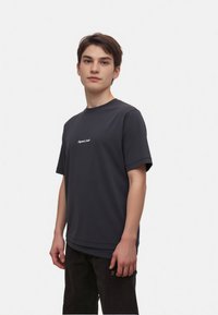 Men's black short-sleeve t-shirt in a smooth fabric, featuring a crew neck and subtle white text on the front. Casual fit, minimal design.