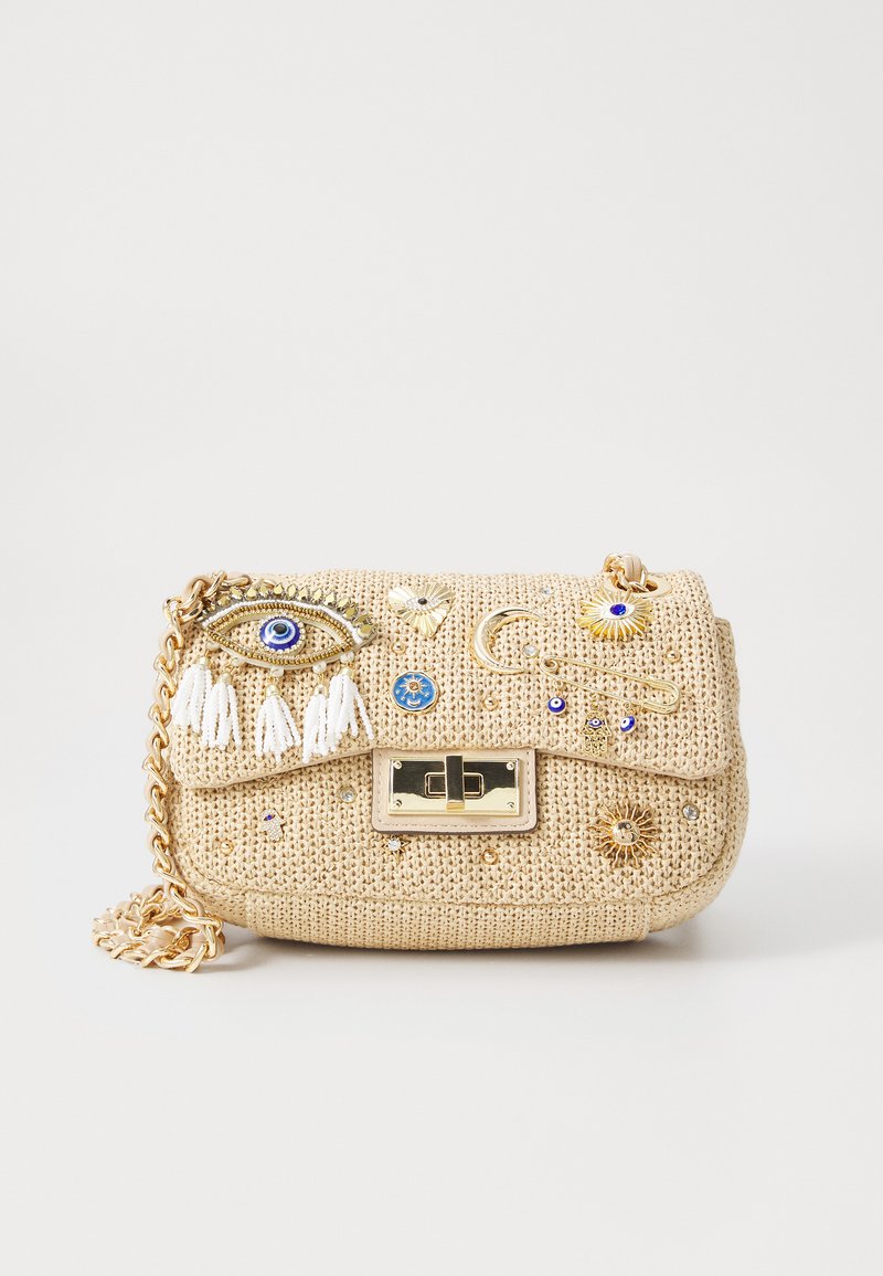 Beige woven handbag with gold hardware, adorned with colorful embellishments, tassels, and decorative motifs. Chain link strap included.