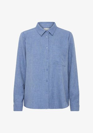 Button-up shirt in light blue fabric with a textured pattern, long sleeves, collar, and a chest pocket. Features contrasting button accents.