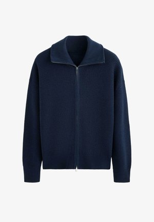 Navy blue knitted zip-up sweater with a wide collar and long sleeves, featuring a textured waffle pattern.