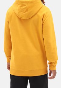 Yellow hooded sweatshirt, cotton blend, medium weight, relaxed fit, featuring ribbed cuffs and hem, simple design without embellishments.