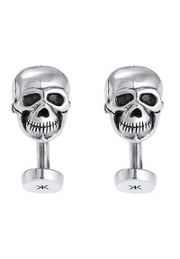 Silver skull cufflinks with a polished finish. Features detailed skull design with hollow eyes and cross-hatched mouth, mounted on a sleek post.