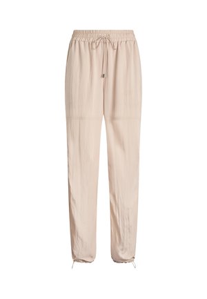 Pantaloni beige chiaro con coulisse in vita, gamba affusolata e orli arricciati, realizzati in un materiale leggero e liscio.