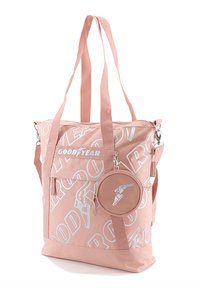 Pink fabric tote bag with dual handles, white logo print, a front pocket, and a detachable round pouch with a winged design.