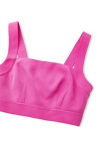 Pink ribbed bralette with wide straps and a fitted design. Features seamless construction and a subtle texture on the fabric.