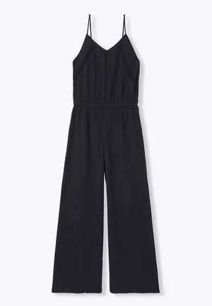 Combinaison noire sans manches avec fines bretelles, encolure en V, taille élastique et pantalon à jambes larges sur fond clair uni.