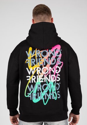 Black hoodie featuring a large, colorful graphic with the words "WRONG FRIENDS" in overlapping, multicolored lettering on the back.