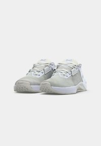Light gray athletic shoes with a textured mesh upper, white accents, padded tongue, and a rubber outsole featuring a triangular pattern.