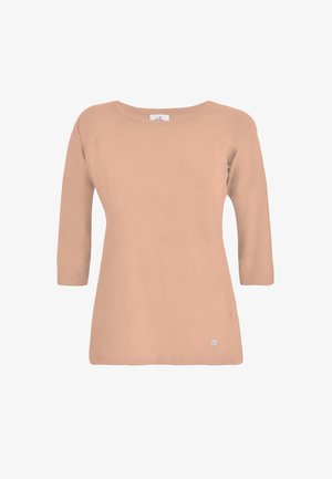 Top de manga larga color melocotón con cuello redondo, textura suave y mangas raglán. Presenta un pequeño logo en el dobladillo y un ajuste holgado.