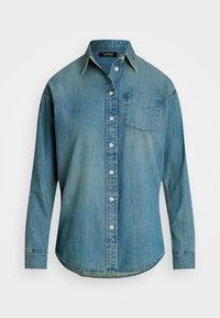 Džinsa krekls izbalinātā zilā krāsā ar pogu aizdari priekšā, norādītu apkakli un vienu krūšu kabatu. Garas piedurknes ar pogu aprocēm un izliekts apakšmala.