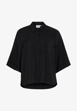 Svart skjorte med knapper, spredt krage og ermer rullet opp til trekvart lengde, med lett buet nederkant og avslappet passform.
