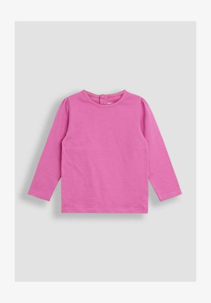 Pikae varrukatega beebipaita ühtlasest erkoranžist värvitoonis, ümmarguse kaeluse ja selja nupuga kinnisegamissega, heledal hallil taustal.