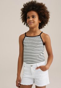 Zwart-wit gestreepte top met dunne bandjes, gecombineerd met witte denimshorts met rafelige zomen en een voorke pocket.