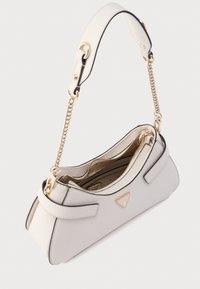 Borsa a mano in pelle crema con silhouette strutturata, bordo nero a contrasto, ferrature dorate e tracolla con catena.