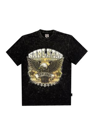 Black T-shirt with a round neckline featuring a graphic design of an eagle and text "KARL KANI EST. 1989" in gold and white. Soft texture.