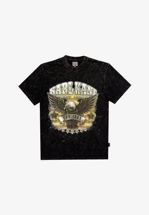 Fekete póló kerek nyakkivágással, amelyen egy sas grafikai design és a "KARL KANI EST. 1989" felirat arany és fehér színben látható. Puha tapintású.