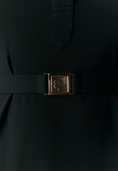 Black dress featuring a belt with a bronze rectangular buckle and a textured fabric. The neckline is pointed, and the waist is defined.