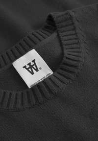 Dark gray knit sweater featuring a ribbed collar. White label with logo and text "DOUBLE Y BY WOOD WOOD" visible at the neckline.