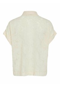 Blusa de crema de manga corta con patrón floral texturizado, diseño con cuello y corte recto en el dobladillo.