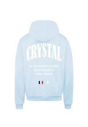 Hedvábně modrá mikina s velkým bílým potiskem "CRYSTAL", detaily Paříže a malou grafikou francouzské vlajky na zádech. Bavlněný materiál, klasický střih.