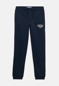 Marinblå mjukisbyxor i bomullsmix, med elastisk midja med dragsnodd, sidofickor och en logotyp på låret.
