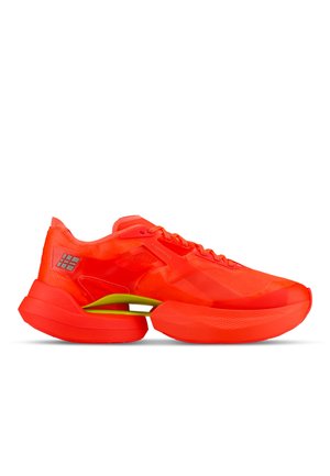 Bright red athletic shoe with thick sole and visible green suspension bar under the arch, shown from the side on white background.