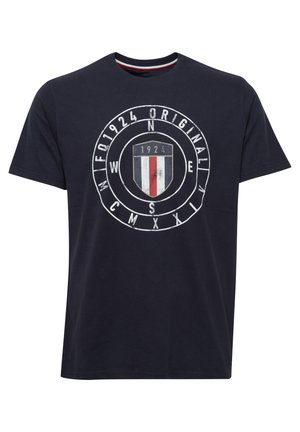 Navy blue cotton T-shirt featuring a central graphic with a shield design, red and white vertical stripes, and circular text. Short sleeves.