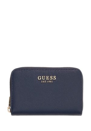 Portefeuille zippé Guess bleu marine avec surface texturée et logo doré "GUESS EST 1981" à l'avant.