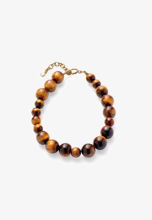 Bracelet avec perles rondes polies en œil de tigre de tailles variées, reliées par une chaîne à fermoir doré sur fond blanc.