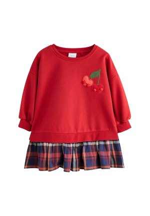 Roter Sweatshirt mit puffigen Ärmeln, verziert mit einer Kirschenapplikation, und schichtweise mit einem navyfarbenen, karierter Rüschensocke am Saum. Material aus Baumwollmischung.