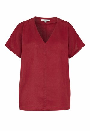 Leinenbluse mit kurzen Ärmeln in tiefrot, V-Ausschnitt und einfache Naht als Detail in der Mitte vorne und an den Ärmeln.