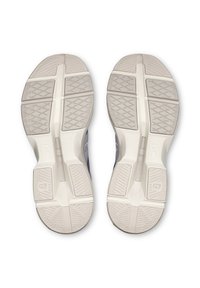 Shoe soles feature a textured white rubber base with multi-directional patterns for grip, bordered by a streamlined grey upper design.