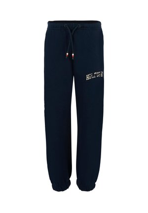 Pantaloni da jogging in cotone blu navy con vita elasticizzata, cordoncino e polsini a coste. Logo "HILFIGER" in colore beige sul lato.