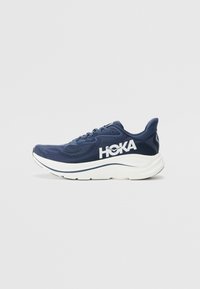 Scarpa da corsa blu navy realizzata in mesh traspirante con logo e dettagli bianchi, dotata di una robusta intersuola bianca e suola testurizzata.