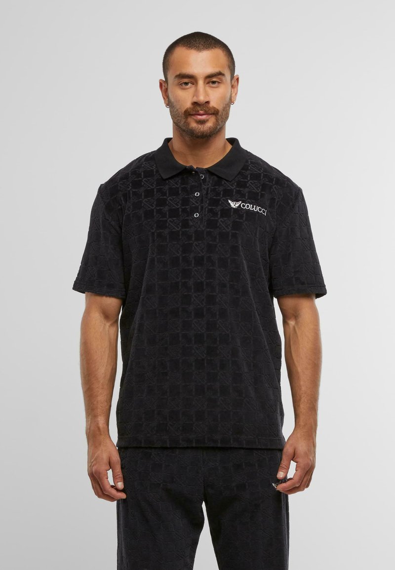 Black textured polo shirt with a collared neck, three buttons, and the "COLUCCCI" logo on the upper left chest. Soft fabric and relaxed fit.