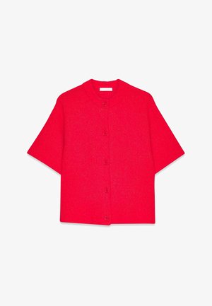 Ryškiai raudonas trumpas rankovėmis kardiganas, turintis apvalų iškirpimą ir priekinį užsegimą mygtukais. Pagamintas iš tekstūruotos megztos medžiagos.