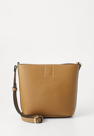 Tan leather crossbody bag with a textured finish, featuring a single adjustable strap, minimalistic design, and white stitching accents.