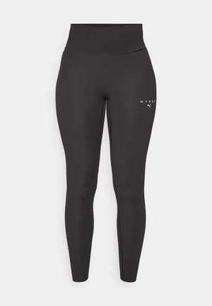 Musthave mustre vestmettete leggings, mille elastne materjal, kõrge vöökoht ja peened logosildid vasakul jalal. Sile tekstuur.