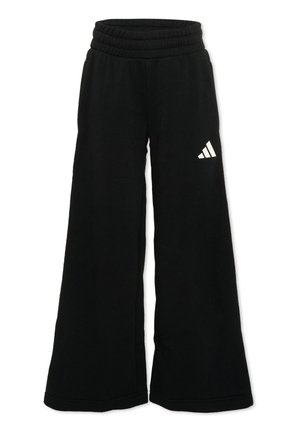 Pantaloni della tuta neri a gamba larga con vita elastica e logo Adidas bianco sulla parte superiore della coscia sinistra.
