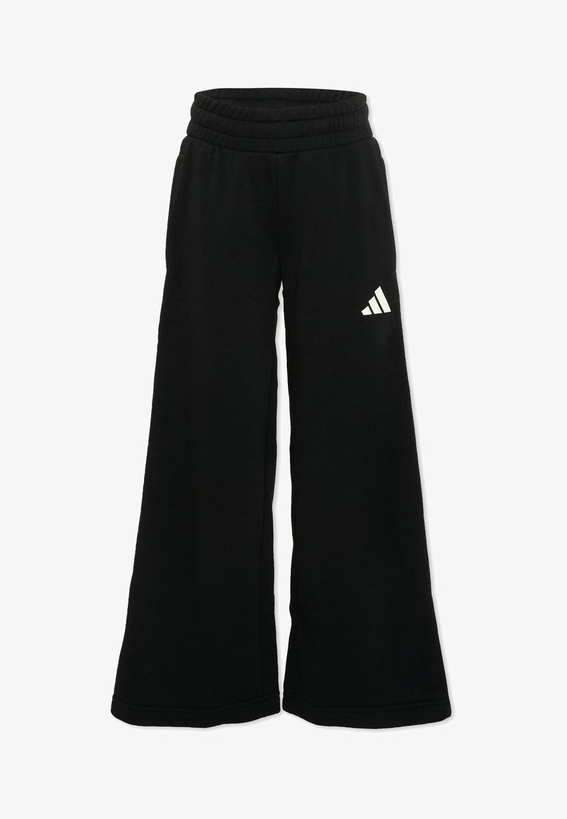 Pantalon de survêtement noir à jambes larges avec taille élastique et logo Adidas blanc sur la partie supérieure de la cuisse gauche.