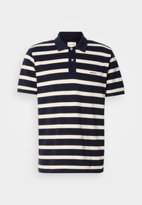 Marineblå og hvitstripete polo skjorte, kort ermer, bomullsmateriale, to-knappers placket, brodert logo på brystet.