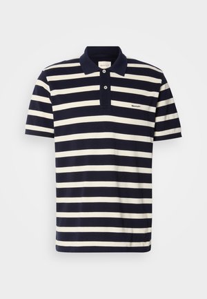 Polo à rayures bleu marine et blanches, manches courtes, en coton, patte de boutonnage à deux boutons, logo brodé sur la poitrine.